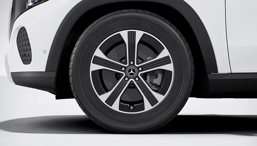 Close-up of a 19-inch 5-spoke alloy wheel with black accents on a white GLE