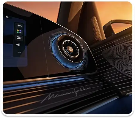 Blue-lit round air vent and ambient lighting beside the dashboard touchscreen
