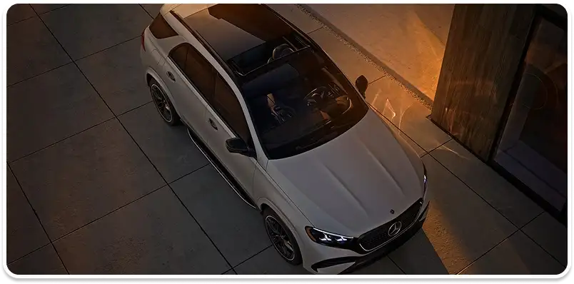 White GLE seen from above parked on a driveway at dusk