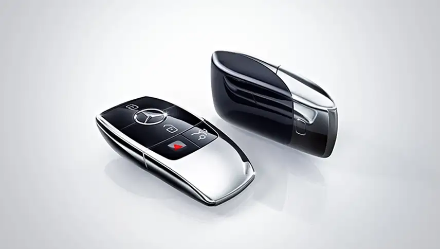 Two Mercedes-Benz SmartKey remotes on a white background