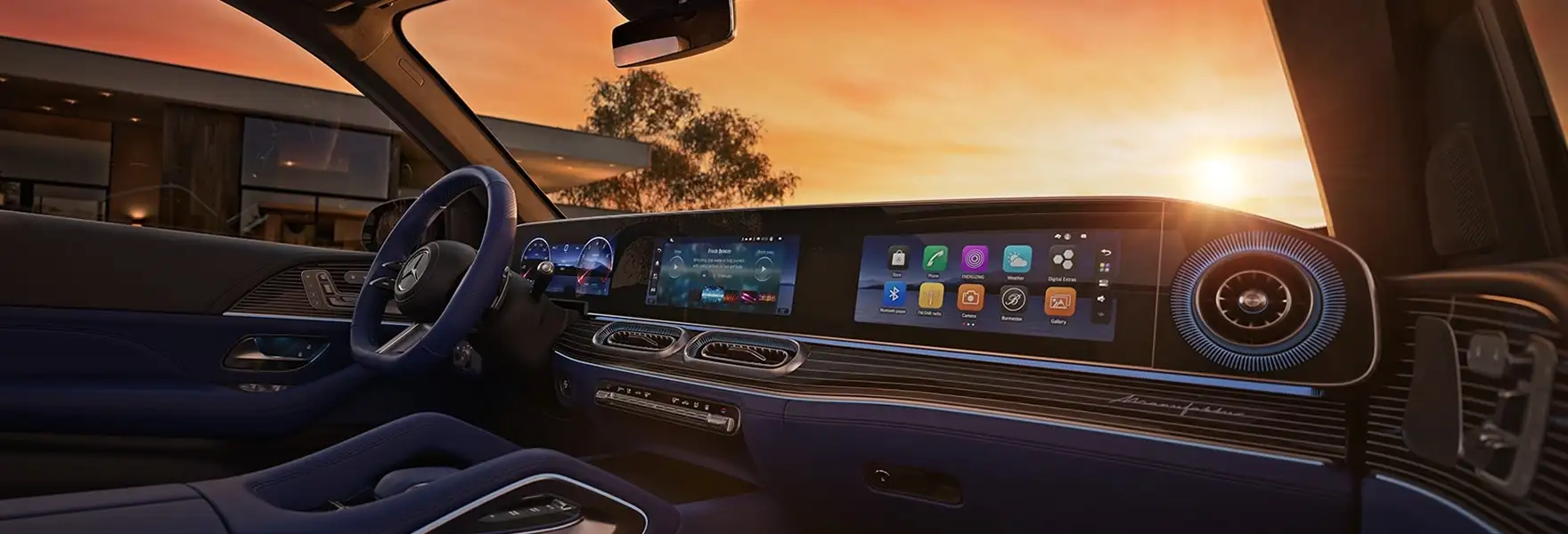 GLE dashboard with the MBUX Superscreen and blue ambient lighting at sunset