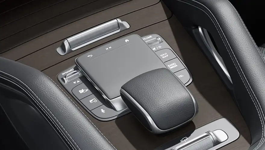 Touchpad controller and hard keys on the wood-trimmed center console