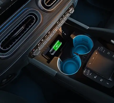 Wireless charging tray and blue-lit cupholders in the GLE center console