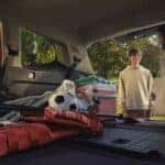 dad and son loading the trunk with camping gear