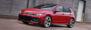 2026 red volkswagen golf gti driving on road