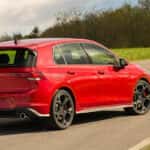 Red 2026 Volkswagen Golf GTI traveling toward nature