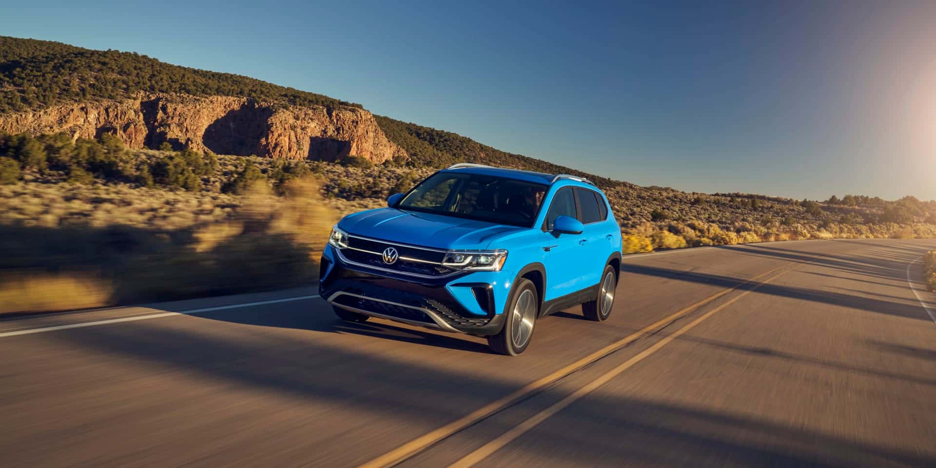 Blue 2026 Volkswagen Taos driving