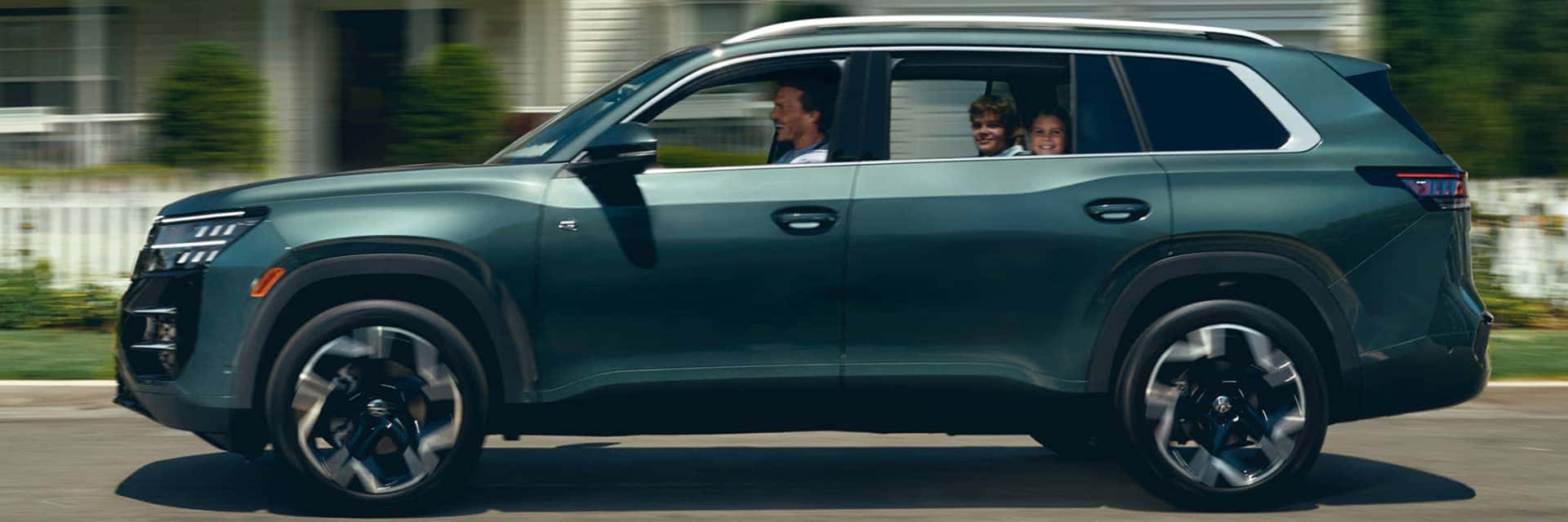 2027 volkswagen atlas with family driving in it
