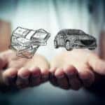 in one hand, money, in the other a car
