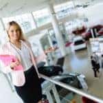 Elegant salesperson working at car dealership