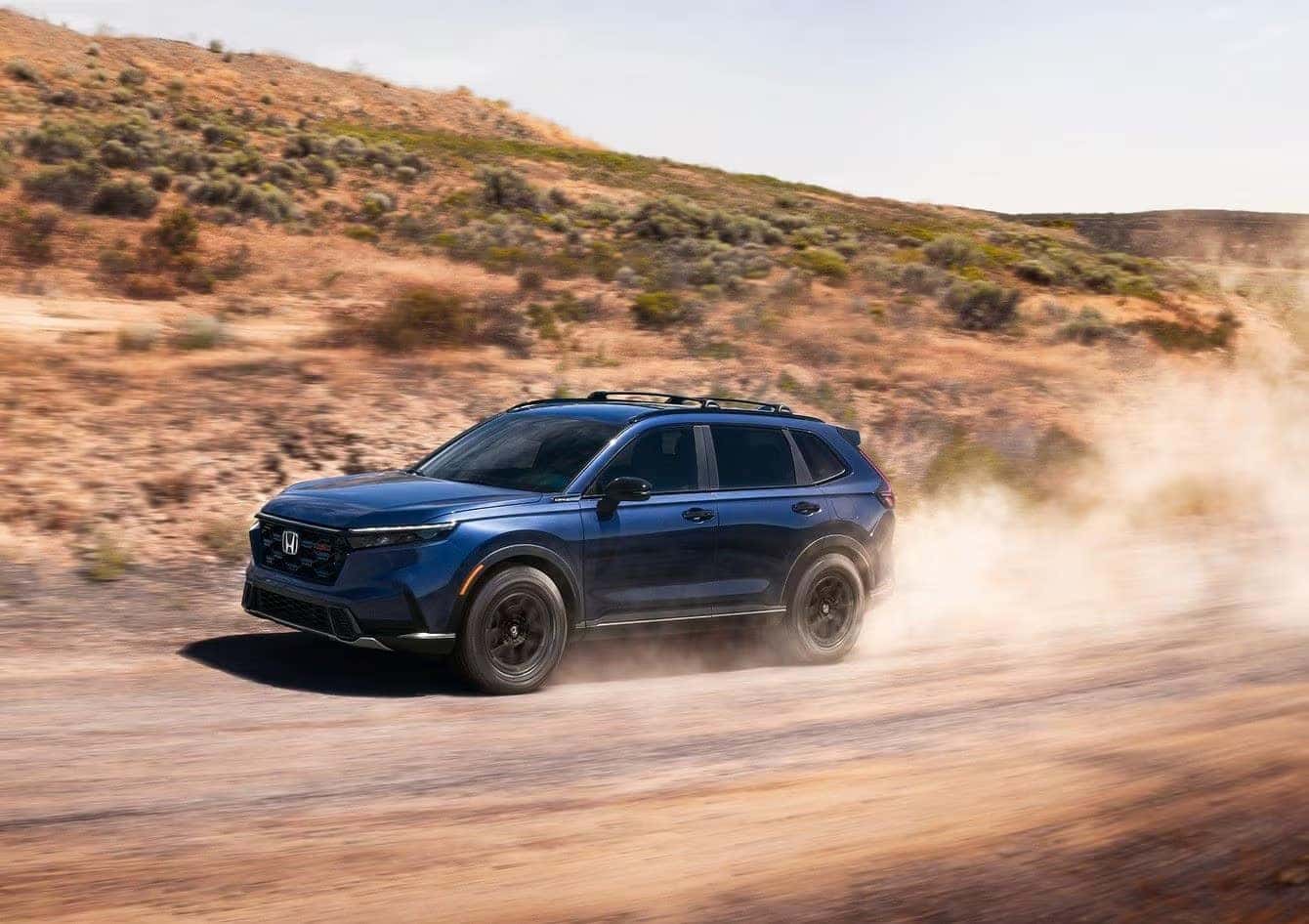 2026 Honda CR-V driving through an urban landscape, highlighting its agile performance.
