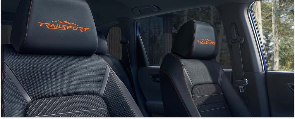 Front seats in a 2026 Honda CR-V TrailSport featuring black upholstery, orange contrast stitching, and embroidered headrests.