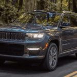 2021 Jeep Grand Cherokee L driving through the woods