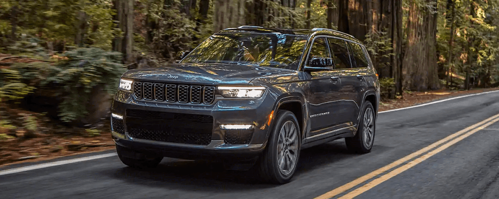 2021 Jeep Grand Cherokee L driving through the woods