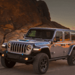2021 Jeep Wrangler 4xe driving on a dirt road