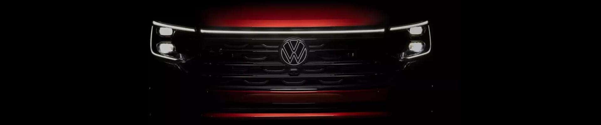Close-up of a car front grille featuring a prominent Volkswagen logo.