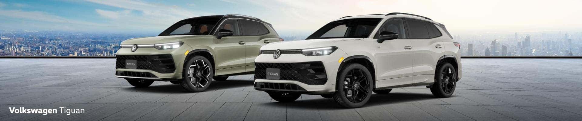 2026 Volkswagen Tiguan SUVs are parked on a rooftop with a city skyline in the background.