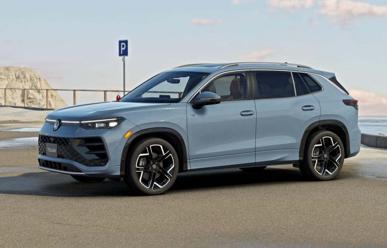 Volkswagen Tiguan SUV is parked by the coast on a sunny day.