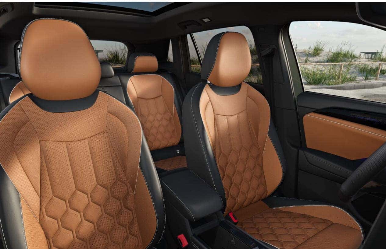 Volkswagen Tiguan interior featuring leather seats with a hexagonal pattern and black accents.