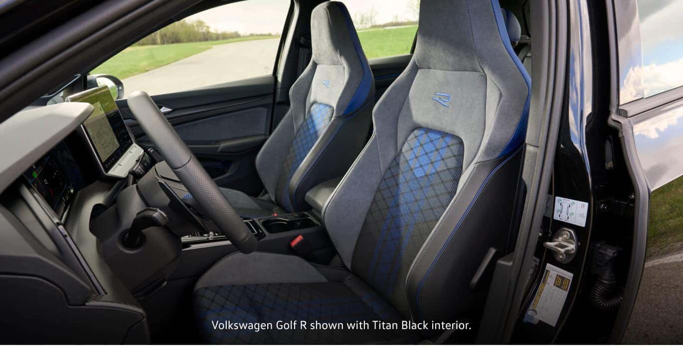 Titan Black interior of a 2026 Volkswagen Golf R featuring sporty front bucket seats with blue accents.