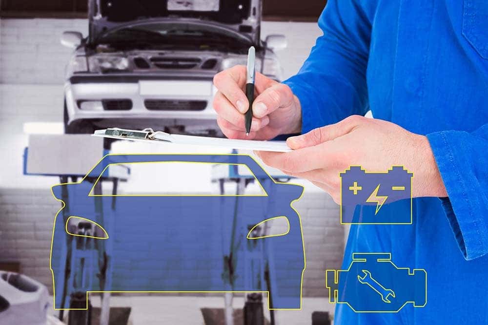 Mechanic writing on clipboard