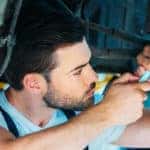 Auto mechanic doing maintenance on car