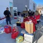 Employees Packing Gifts For We're Here For You Project