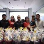 Group of people standing behind festive Easter Baskets