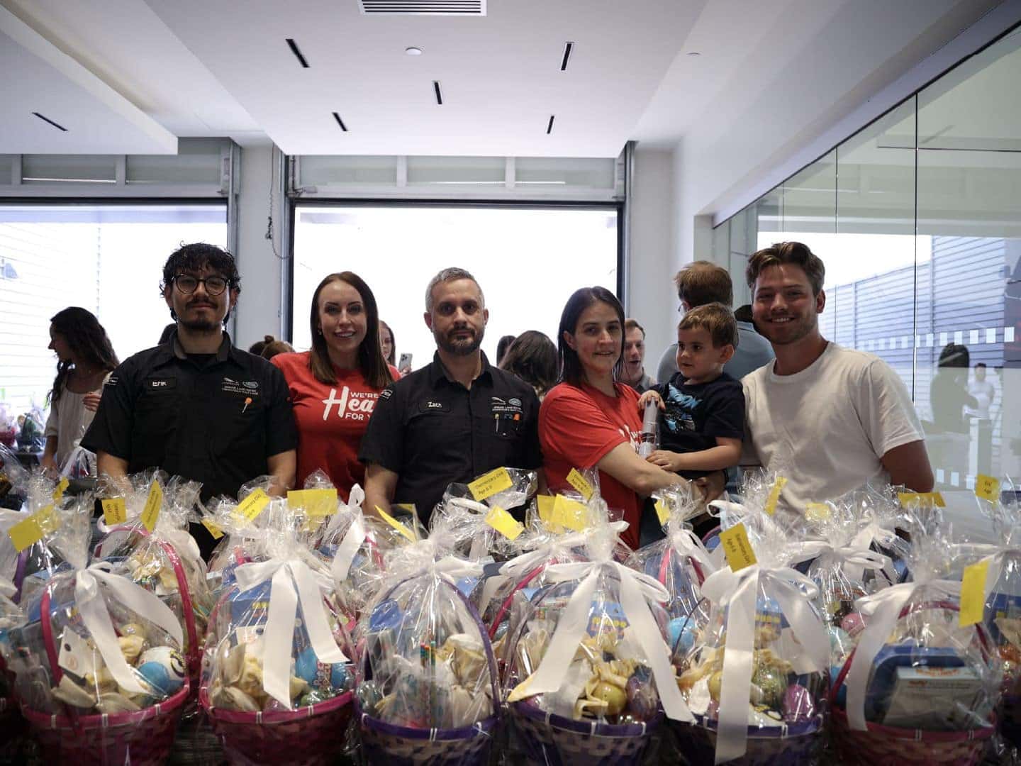 Group of people standing behind festive Easter Baskets