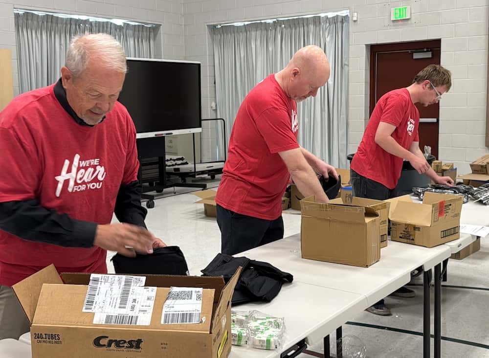 Employees pack hygiene kits