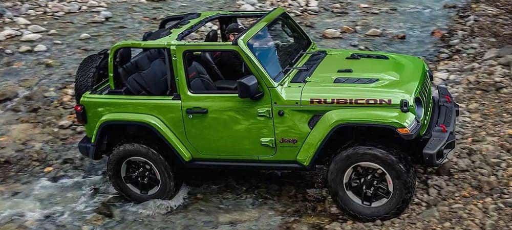 Green 2019 Jeep Wrangler Rubicon crossing stream
