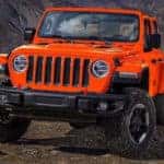 Orange Jeep Wrangler off-roading