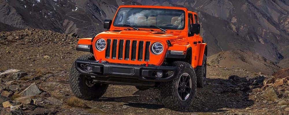 Orange Jeep Wrangler off-roading