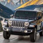 Jeep Wrangler towing a boat on the highway