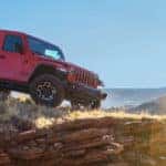 Red Jeep Gladiator parked on edge of cliff
