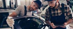 Two mechanics appraising vehicle