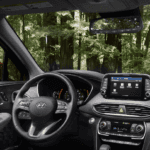 2020 Hyundai Santa Fe interior steering wheel and dashboard looking out on forest