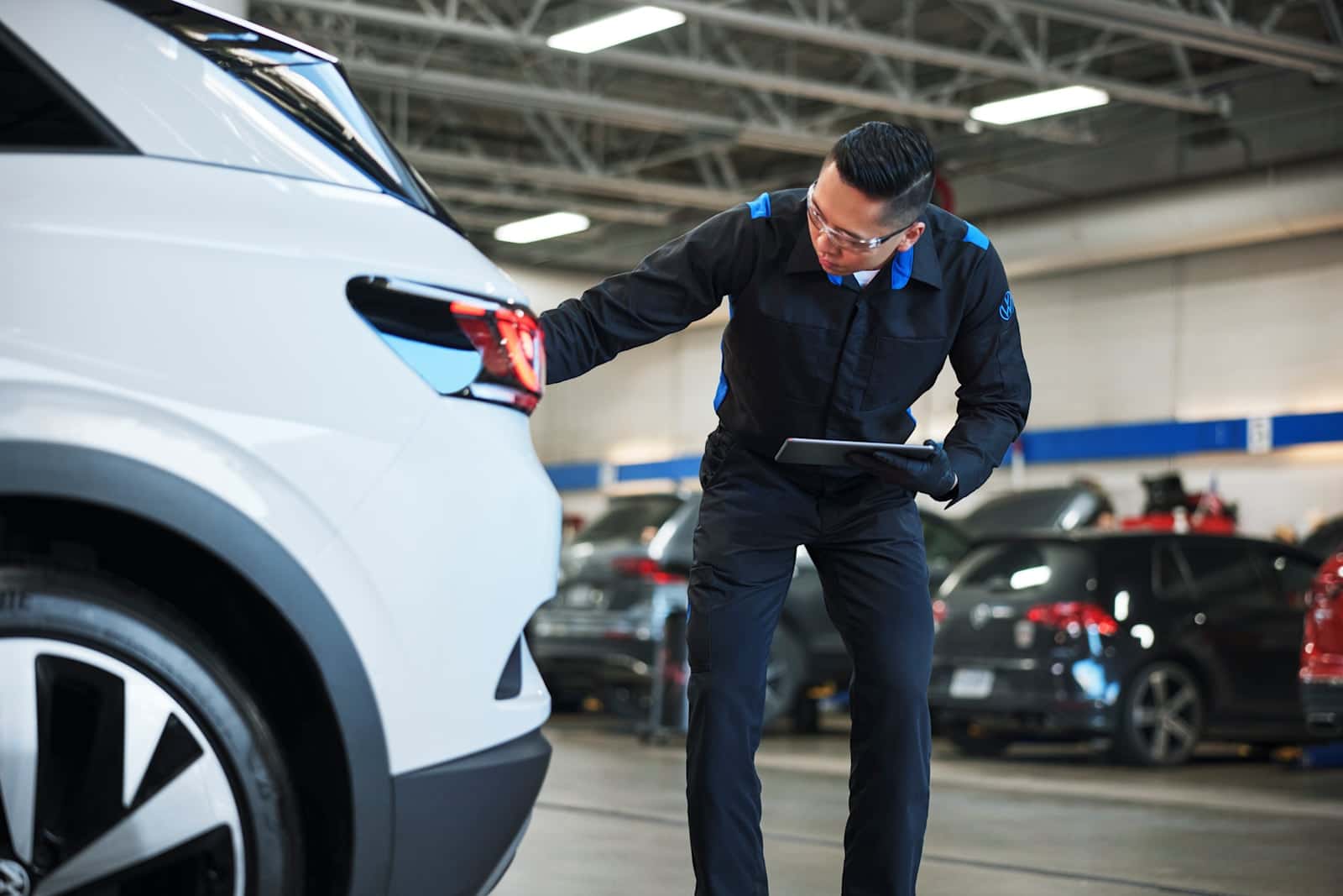 Certified Volkswagen service technician inspecting engine and mechanical components using OEM diagnostic equipment at Midlands Volkswagen in Columbia, SC