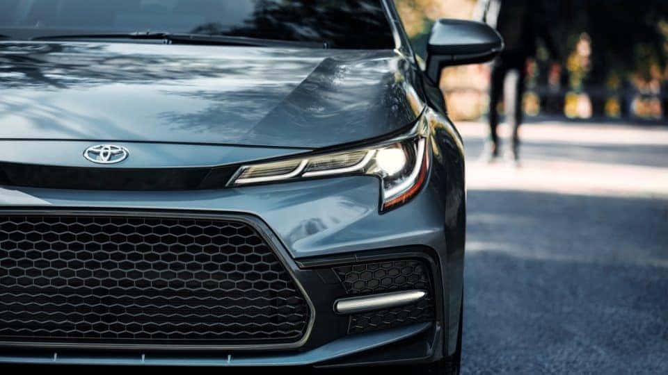 Close-up view of front grille and headlight of a silver 2020 Toyota Corolla