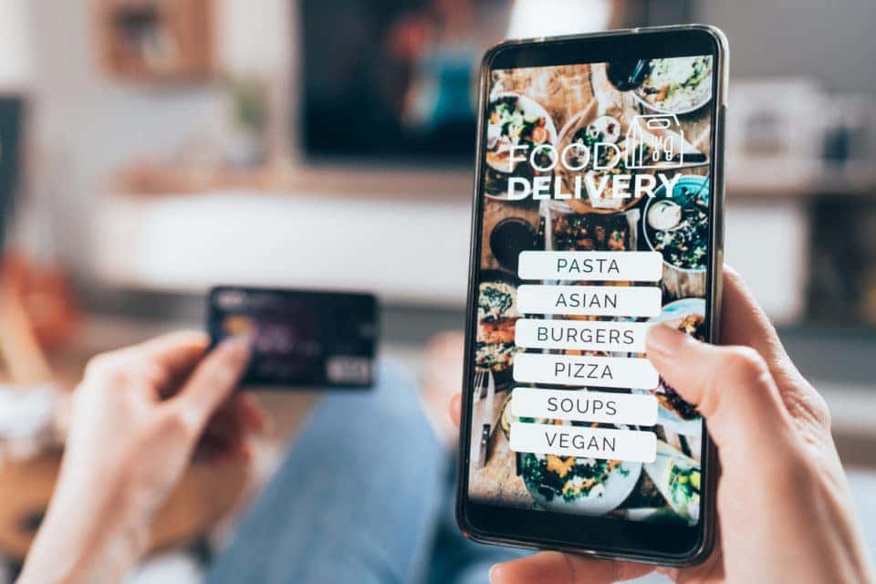 Woman ordering food online on her electronic device