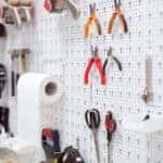 Picture of working tools hanging on board in workshop
