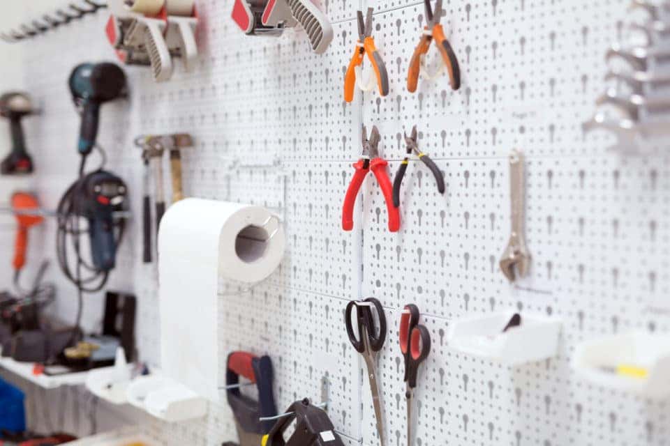 Picture of working tools hanging on board in workshop