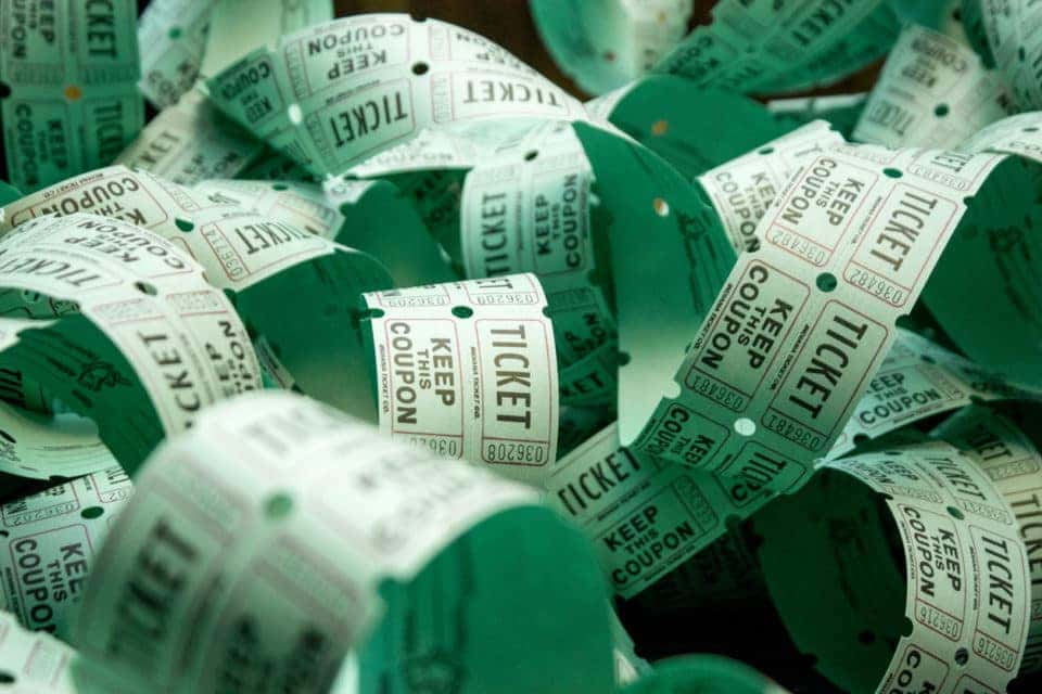 Roll of green admit one coupon raffle tickets for lottery or raffles of charity