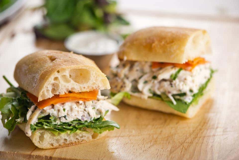 Chicken salad sandwich served on toasted whole baguette with melted Swiss cheese, sautéed onions, lettuce, tomato, mayonnaise and seasoned salt and pepper.