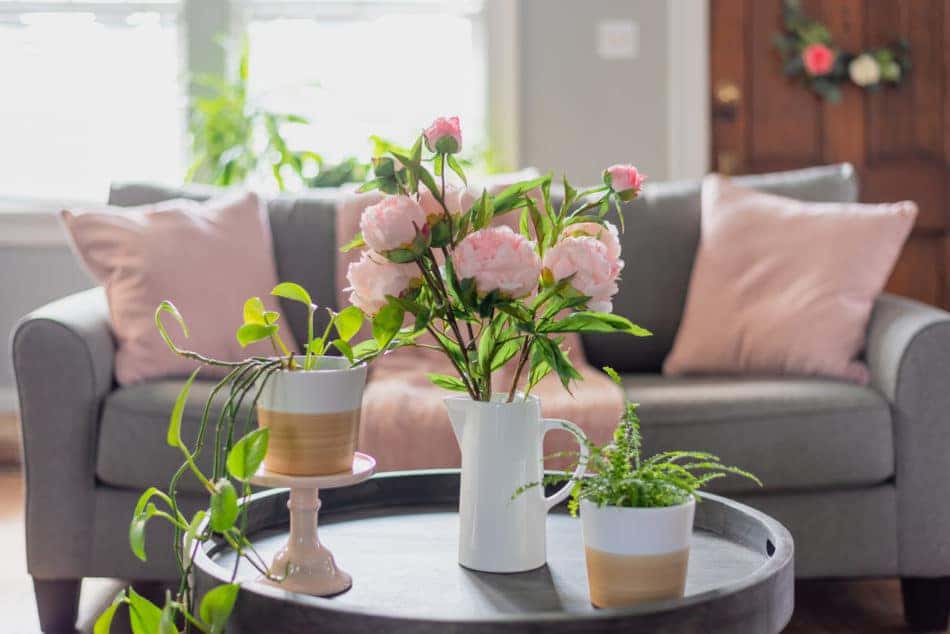 Living room decorated for spring with pink and green flowers