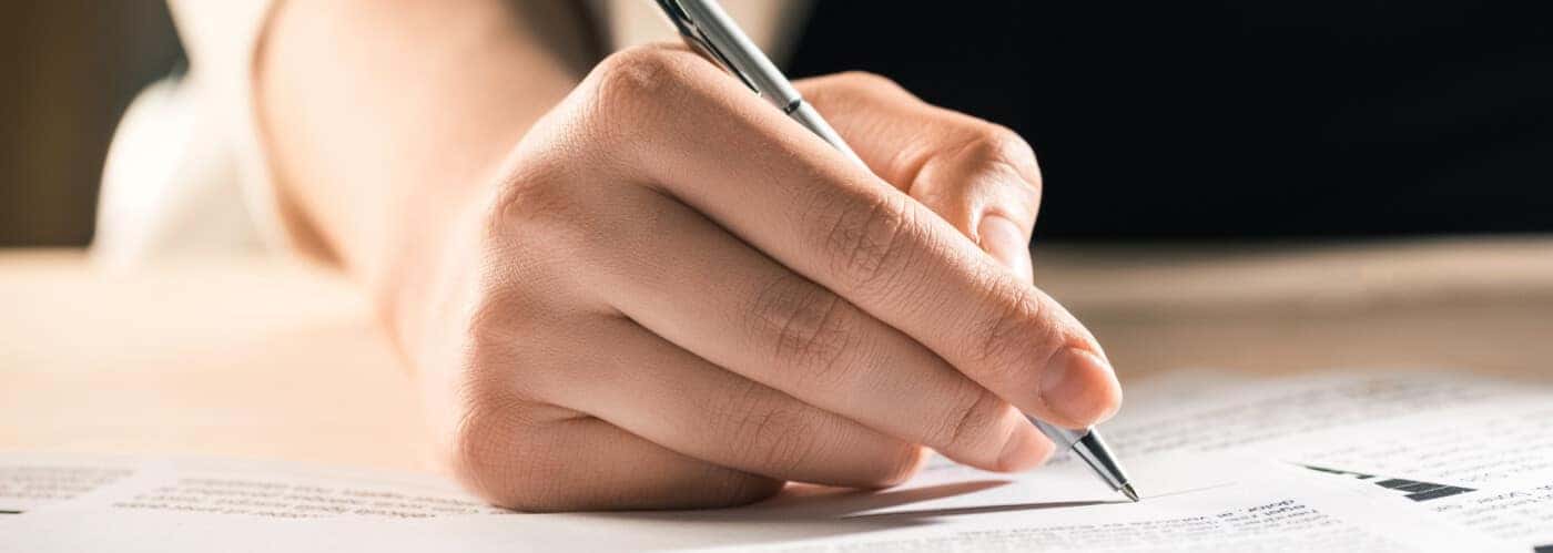 Woman Signing Paperwork