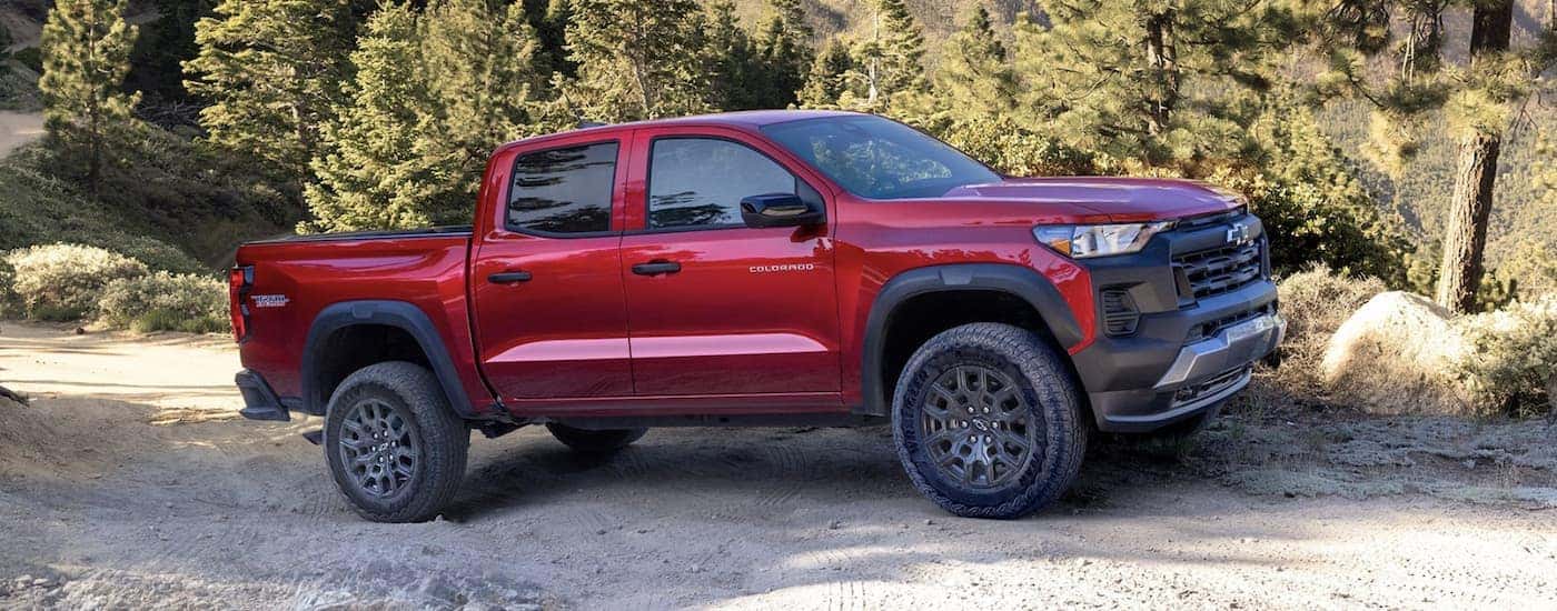 A red 2023 Chevy Colorado Trail Boss parked off-road and angled right.