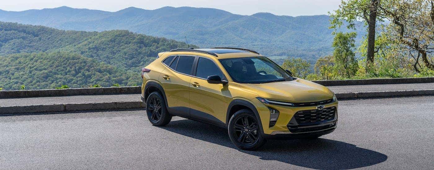 A yellow 2024 Chevy Trax ACTIV is shown from the front at an angle.