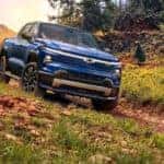 A blue 2025 Chevy Silverado RST is shown from the front at an angle.