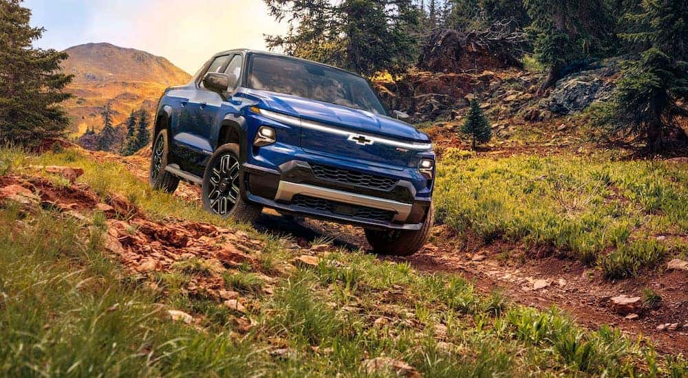 A blue 2025 Chevy Silverado RST is shown from the front at an angle.